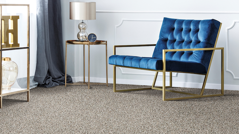 soft carpet in a stylish living room with a blue velvet chair